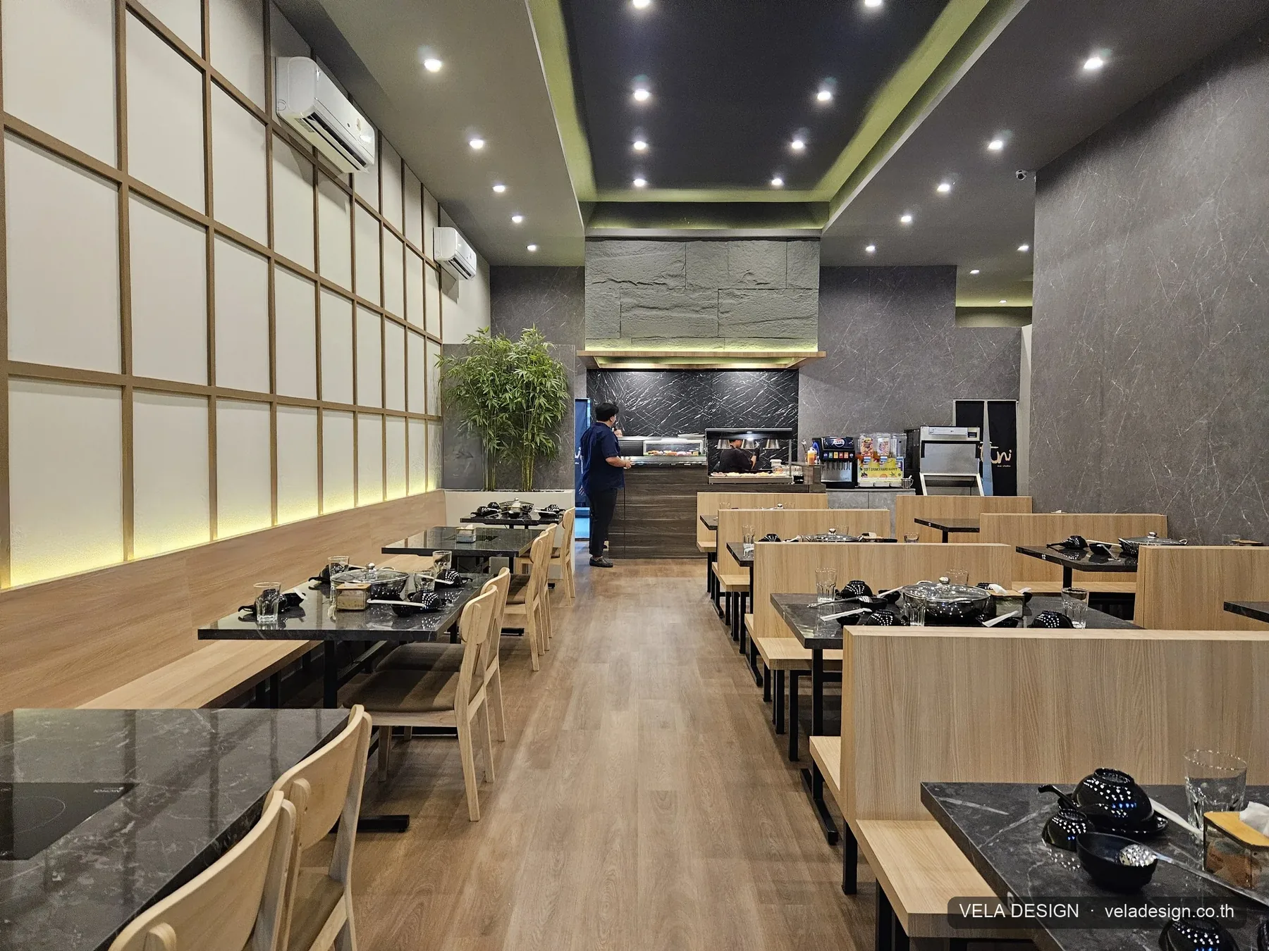 โซนรับประทานอาหารหลักของร้าน Ani Shabu หลังรีโนเวท — โต๊ะหินสองฝั่ง ทางเดินกลาง ผนังไม้และแสงซ่อน